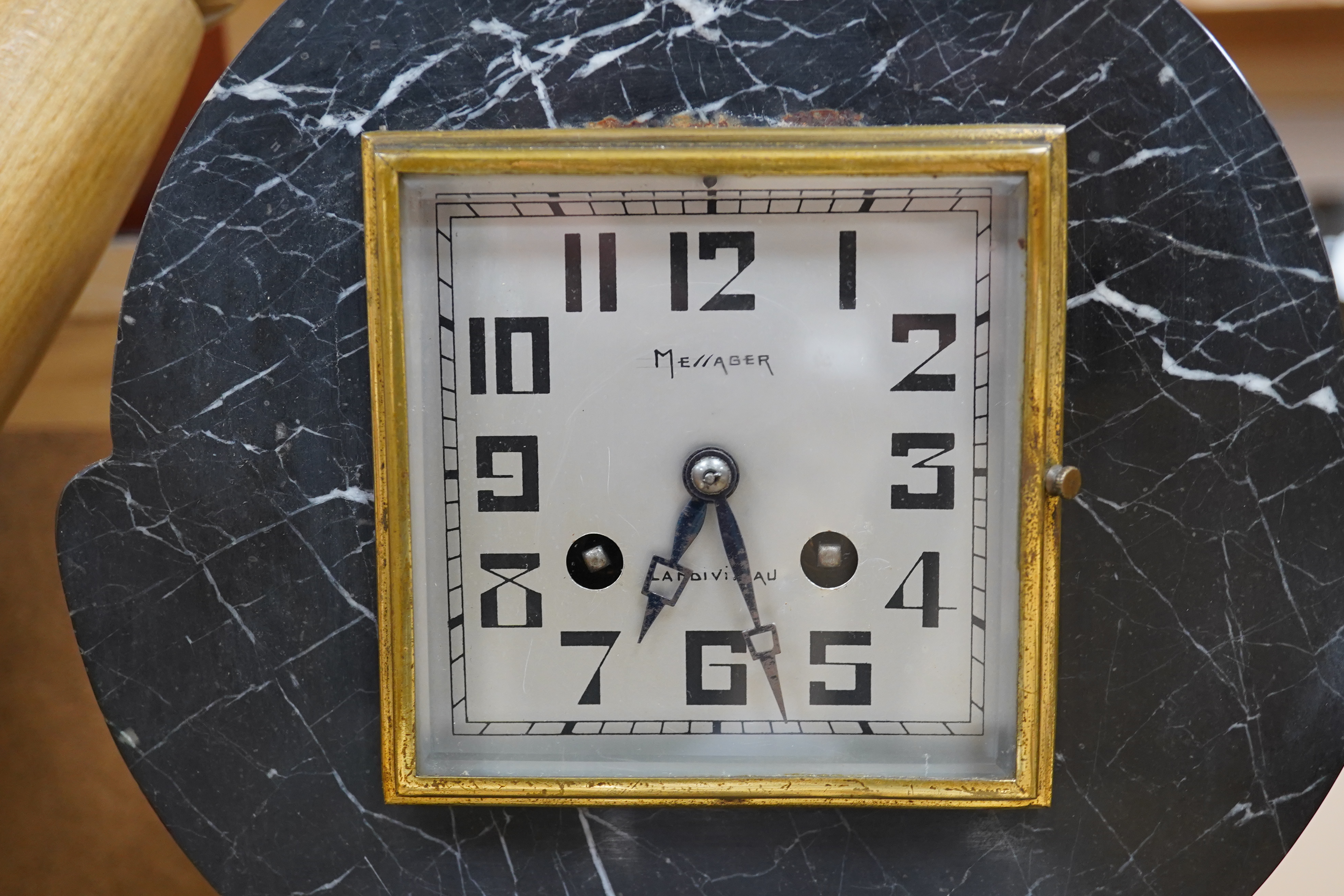 A French Art Deco black and white marble clock, with an ornately painted Spelter figure of a seated lady, width 62cm. Condition - good, unknown if clock in working order